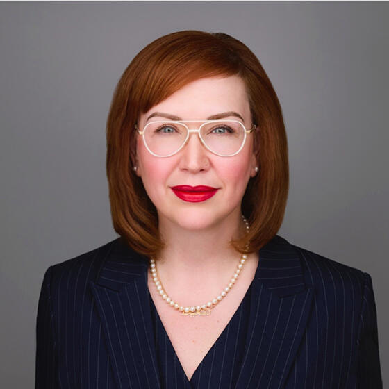 Portrait of red haired women in a dark suit