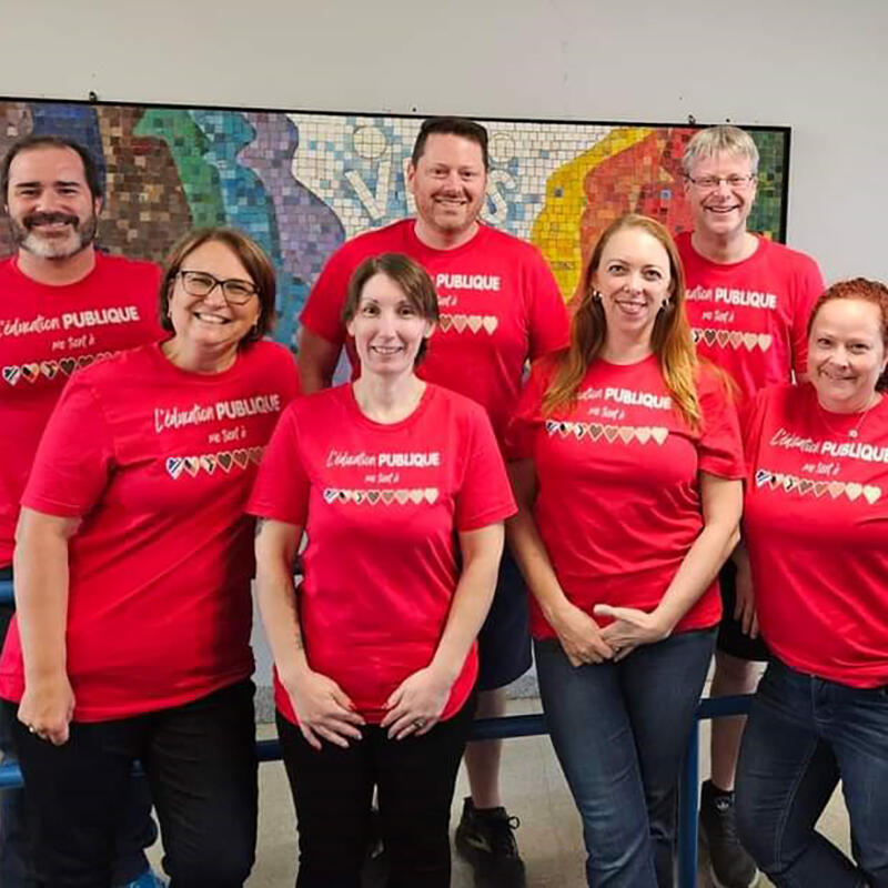 A group of teachers wearing red t-shirts