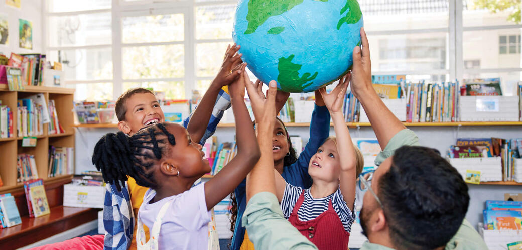 Group of grad 2 students holding up a globe