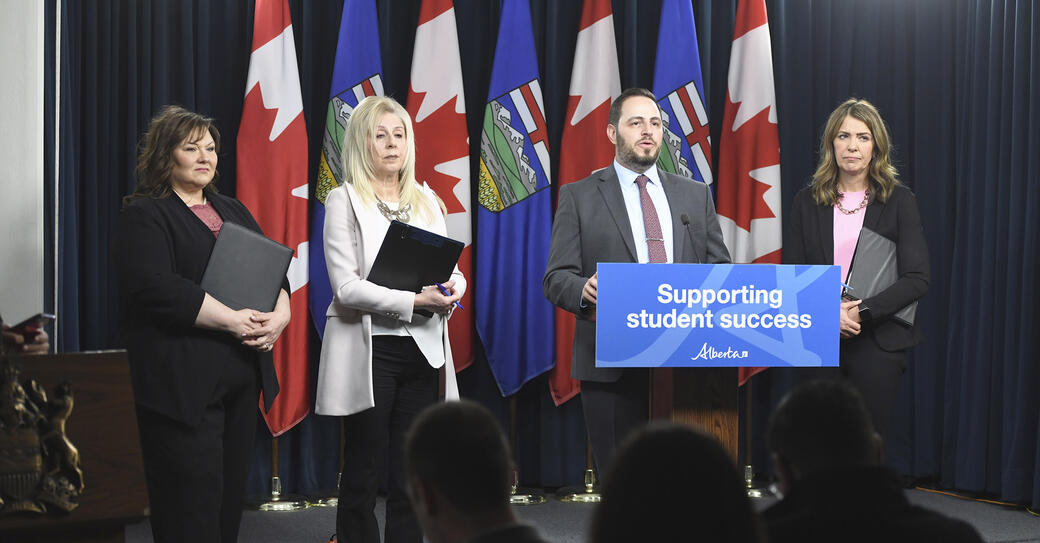 Government officials present the education budget at a press conference