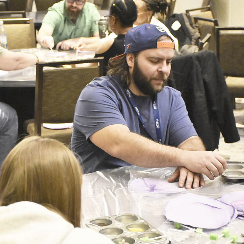 Conference attendees create art using coffee filters