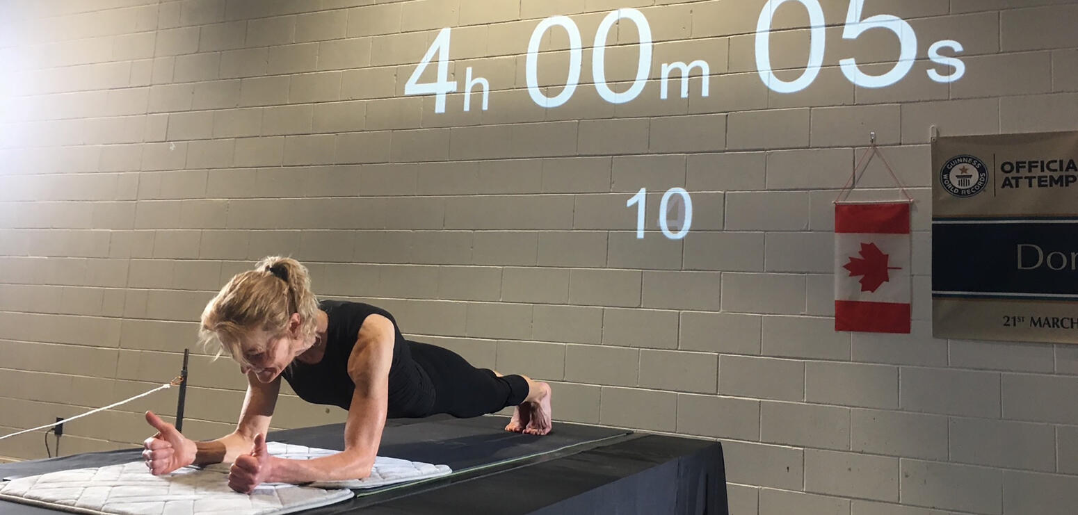 A teacher holds a plank position for over four hours to set a new world record
