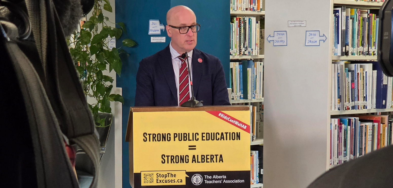 A passionate man speaking at a podium in a library