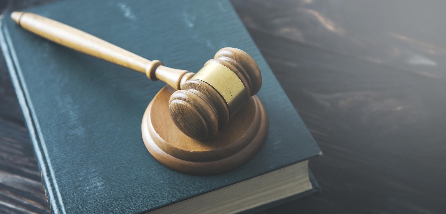 A gavel resting on a book