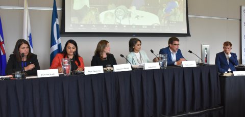 UCP Leadership candidates sitting along a table speaking in front of teachers at Summer Conference