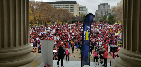 Rally for Public Education crowd captured between the pillars of the Alberta Legislature