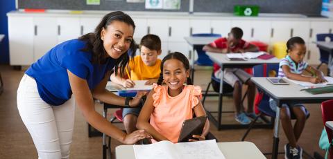 Black female teacher with student in wheelchair