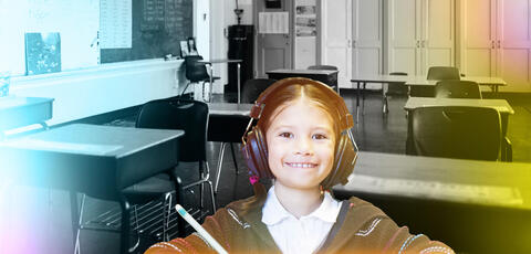 Girl wearing headphones in front of a black and white classroom