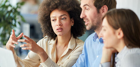Group discussing over laptop