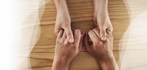Holding hands over tabletop