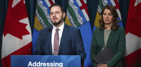 Alberta's premier and minister of Education and Childcare at a press conference