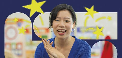 Image of a teacher in front of a bulletin board