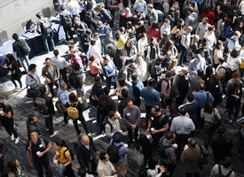 Crowd of people gathered in a trade show hall