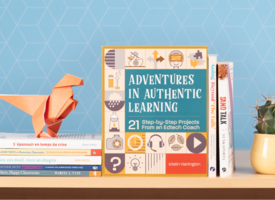 Picture of featured books stacked for the spring edition of Learning Commons. There is an origami dinosaur perched on top of the books.