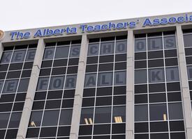 ATA Building with the statement Keep Schools Safe for All Children in the windows of the top two floors