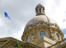 Alberta Legislature dome with blue provincial flag