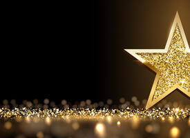 A gold star on a dark background