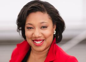 Women with short hair wearing red blazer