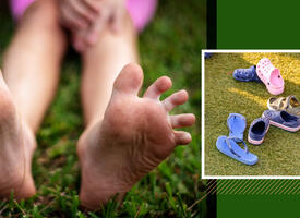 A close up image of feet next to a group of shoes.