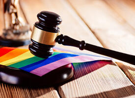 A gavel resting on a pride flag