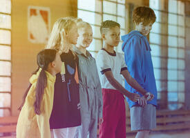 Children standing in a line in a gym