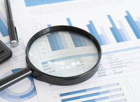 Magnifying Glass on papers with charts
