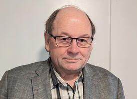 Portrait of  late middle age balding man in blazer