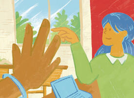 A teacher points to one of her students in a classroom