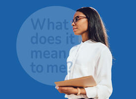 Women wearing glasses and white blouse holding a book