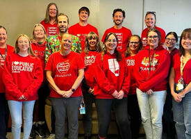 Teachers stand in their red t-shirts