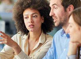 Group discussing over laptop