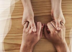 Holding hands over tabletop