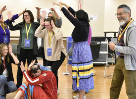 Group of participants do a group dance