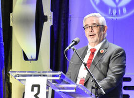 ATA Executive secretary speaks at a podium