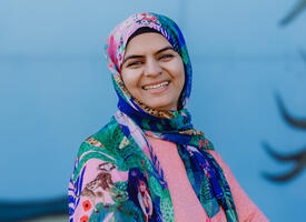 Profile photo of Huma Kashif in front of a local mural in Slave Lake.