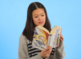 Portrait shot of a pre-teen girl reading manga. 