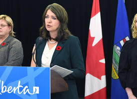 Premiere Smith at a podium speaking about changes to the Education Act