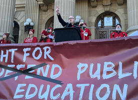 Jason Schilling stands in front of a crowd at a rally