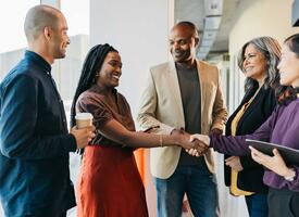Multiracial group shaking hands and smiling