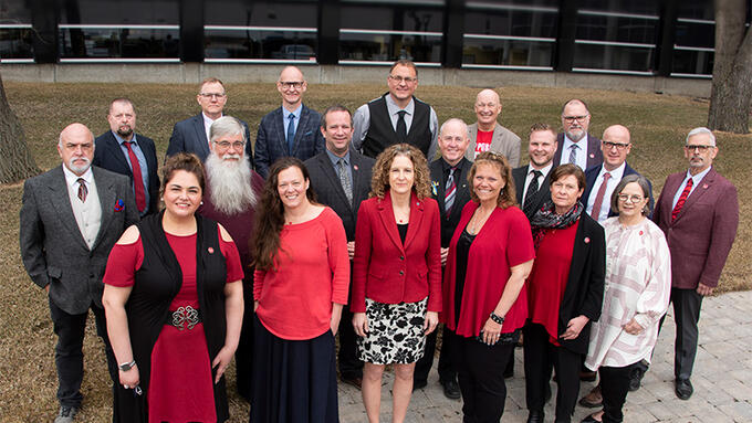 Outside photograph of the ATA's Provincial Executive council wearing red for Ed in front of the Association's building.