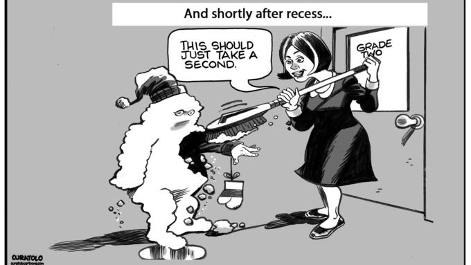 A teacher using a brush to wipe off a snow-covered child