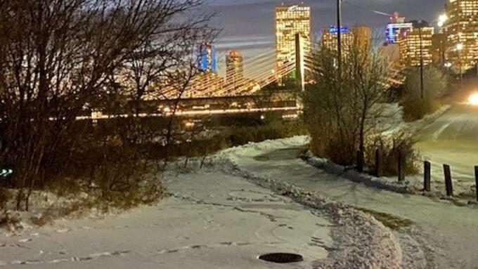 A snow-covered trail with a view of downtown Edmonton