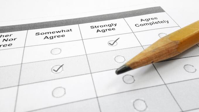 Pencil laid across printed survey that's partially filled out