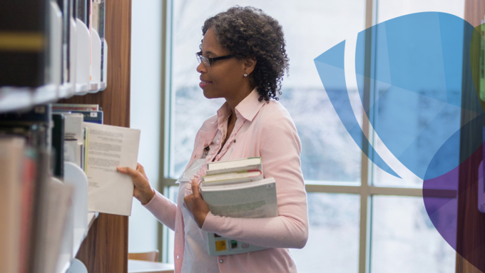 Women standing library restacking the shelves 