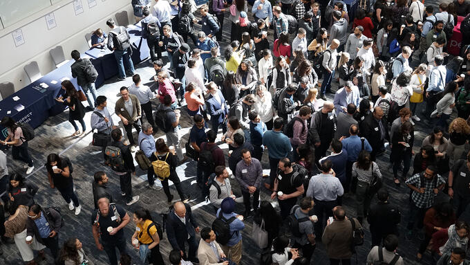 Crowd of people gathered in a trade show hall