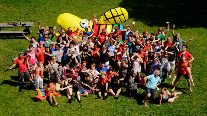 Aerial photo of campers in front of a giant inflated firefly