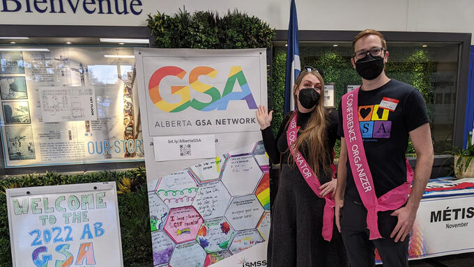 Two people standing in front of a GSA display