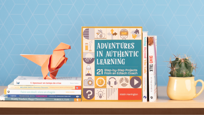 Picture of featured books stacked for the spring edition of Learning Commons. There is an origami dinosaur perched on top of the books.