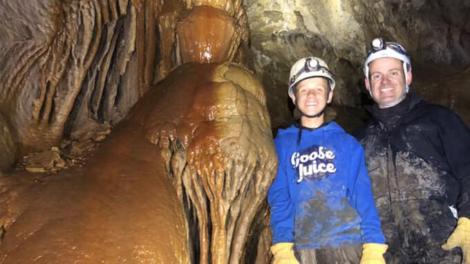 Two people standing in a cave