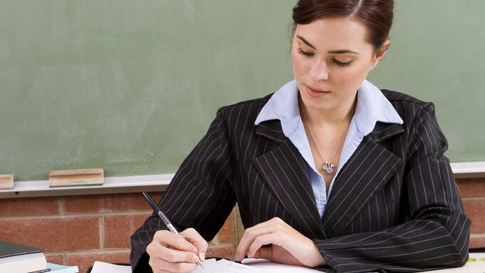 Teacher sitting at a desk